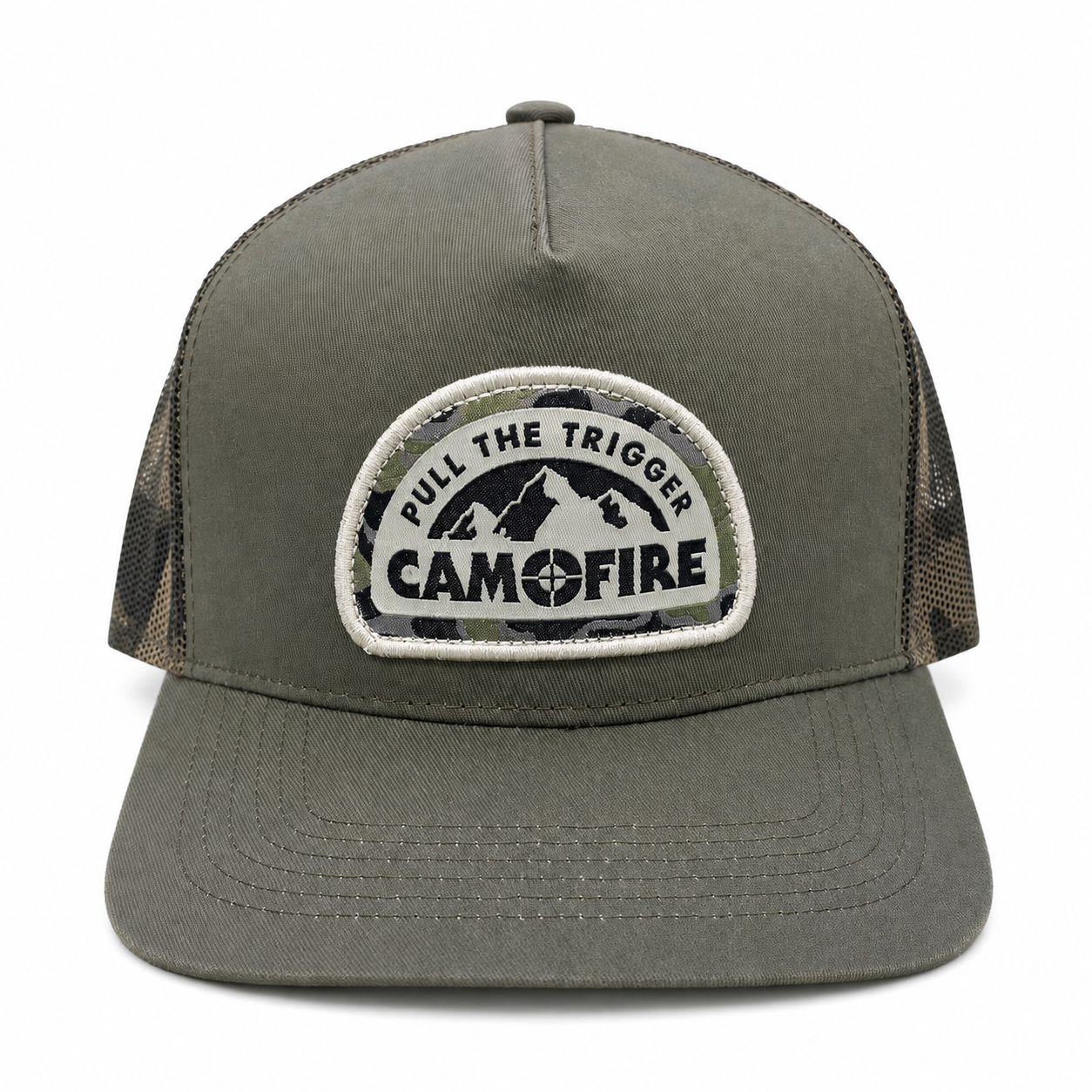 An olive green trucker hat with a camouflage-patterned mesh back and a circular embroidered patch on the front that reads 'PULL THE TRIGGER CAMFIRE' with a mountain graphic.