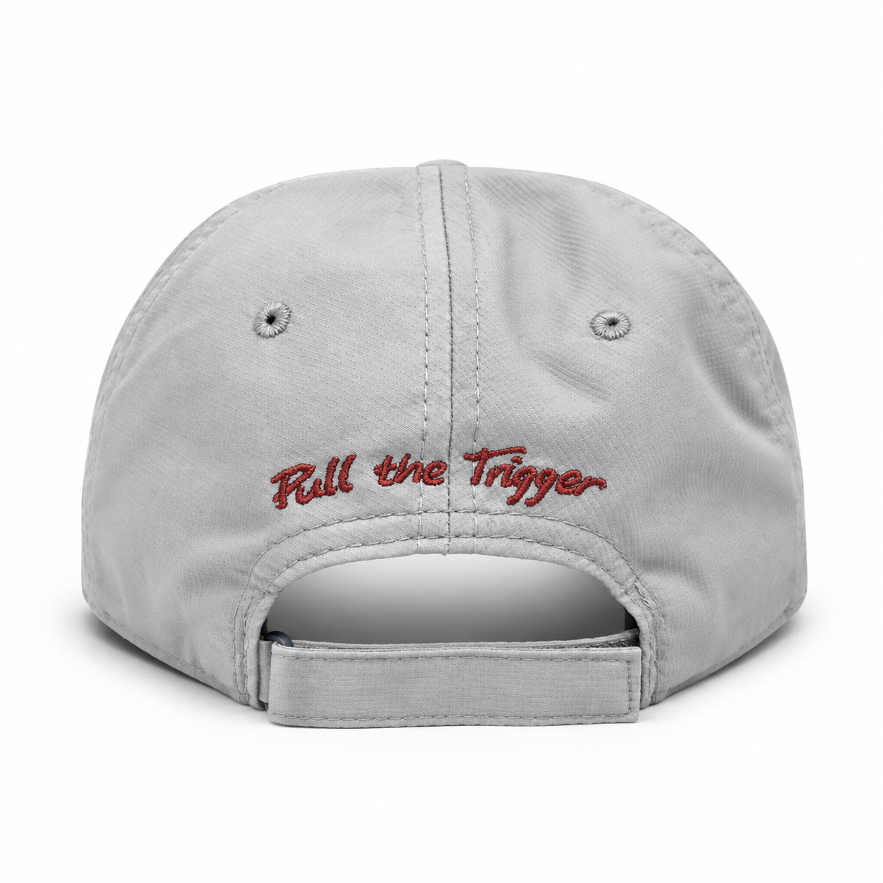 The back of a light gray cotton baseball cap featuring red embroidered text that reads 'Pull the Trigger' on a clean white background.