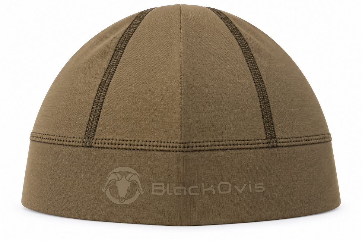 A close-up studio shot of a BlackOvis ski beanie in a warm brownish-tan color, featuring dark contrast stitching and a tonal logo on the front cuff.