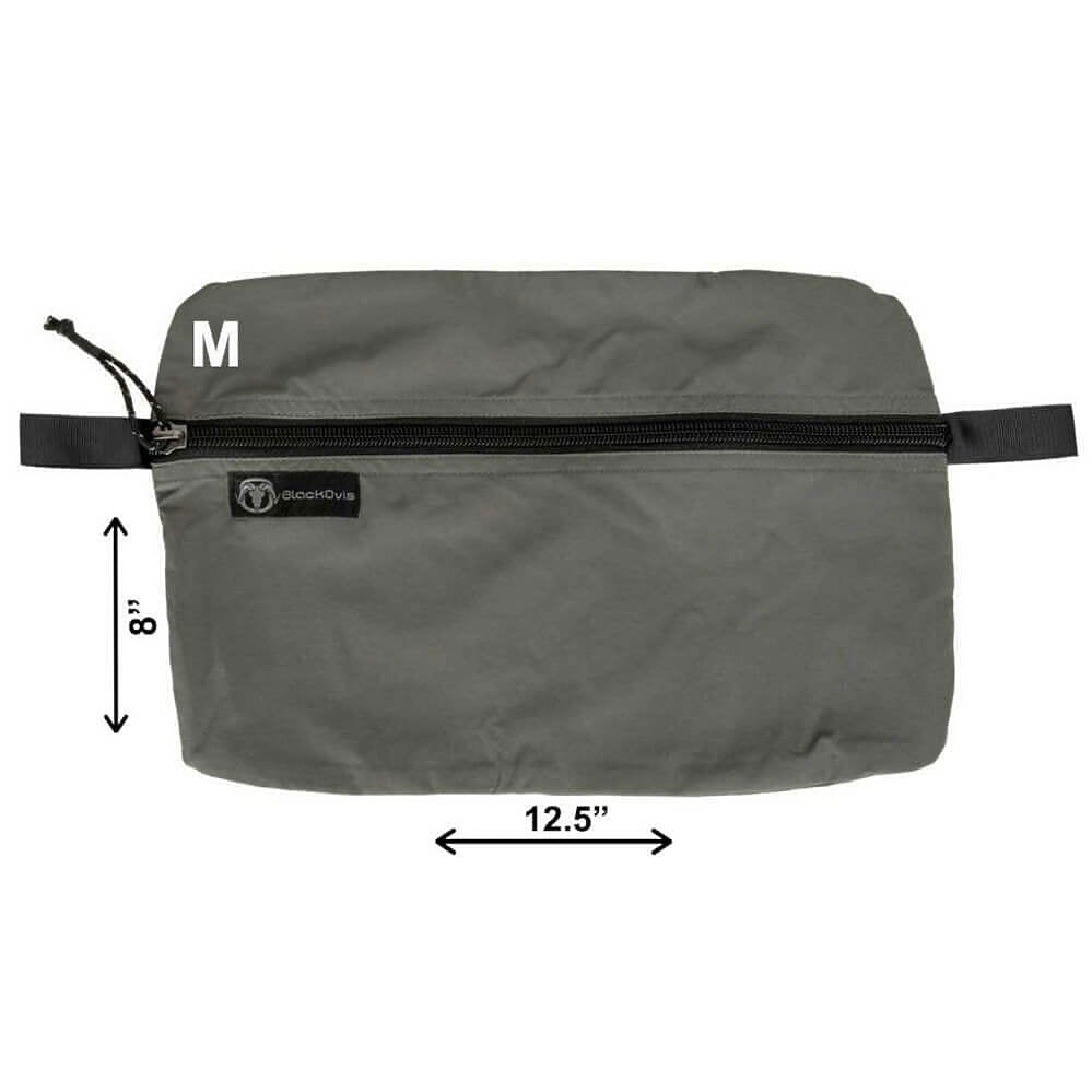 A gray rectangular zippered pouch with black trim and a small black brand label, shown on a white background with dimension arrows indicating 8 inches tall by 12.5 inches wide.