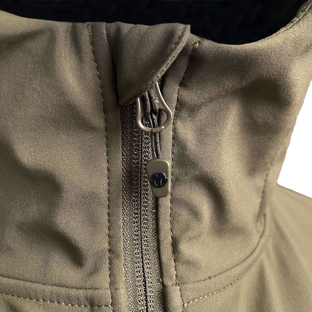 Close-up of a zippered jacket in olive green fabric, showing the zipper pull and collar area.