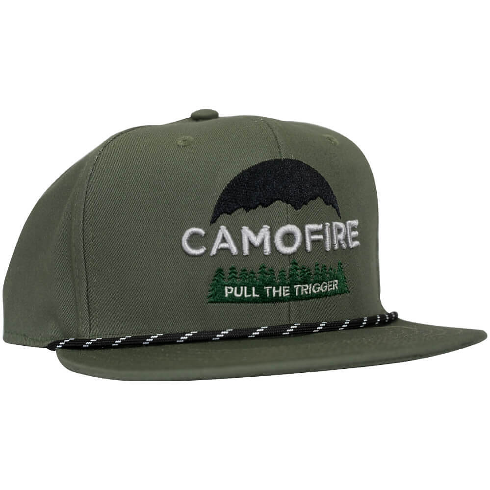 An olive green flat-brim snapback cap featuring a black embroidered mountain and white embroidered 'CAMOFIRE' text, with 'PULL THE TRIGGER' in green and white below it. A braided black and white rope detail runs across the front of the brim.