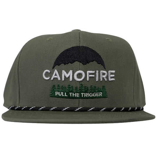 An olive green flat-brim cap featuring embroidered graphics on the front. The design includes a black mountain silhouette, the word 'CAMOFIRE' in white, green pine trees, and the phrase 'PULL THE TRIGGER' in white text on a green background.