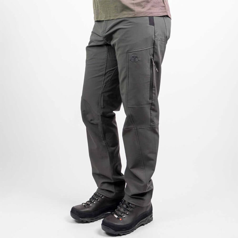 Dark gray technical outdoor pants shown on a model from the waist down, paired with black hiking boots against a light gray studio background.