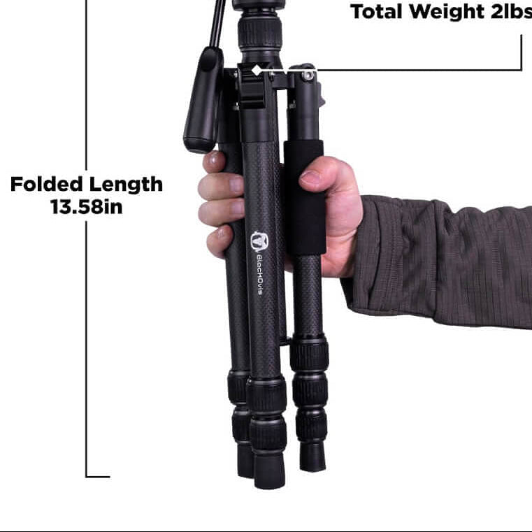 Black tripod held by a hand with measurements labeled on a white background